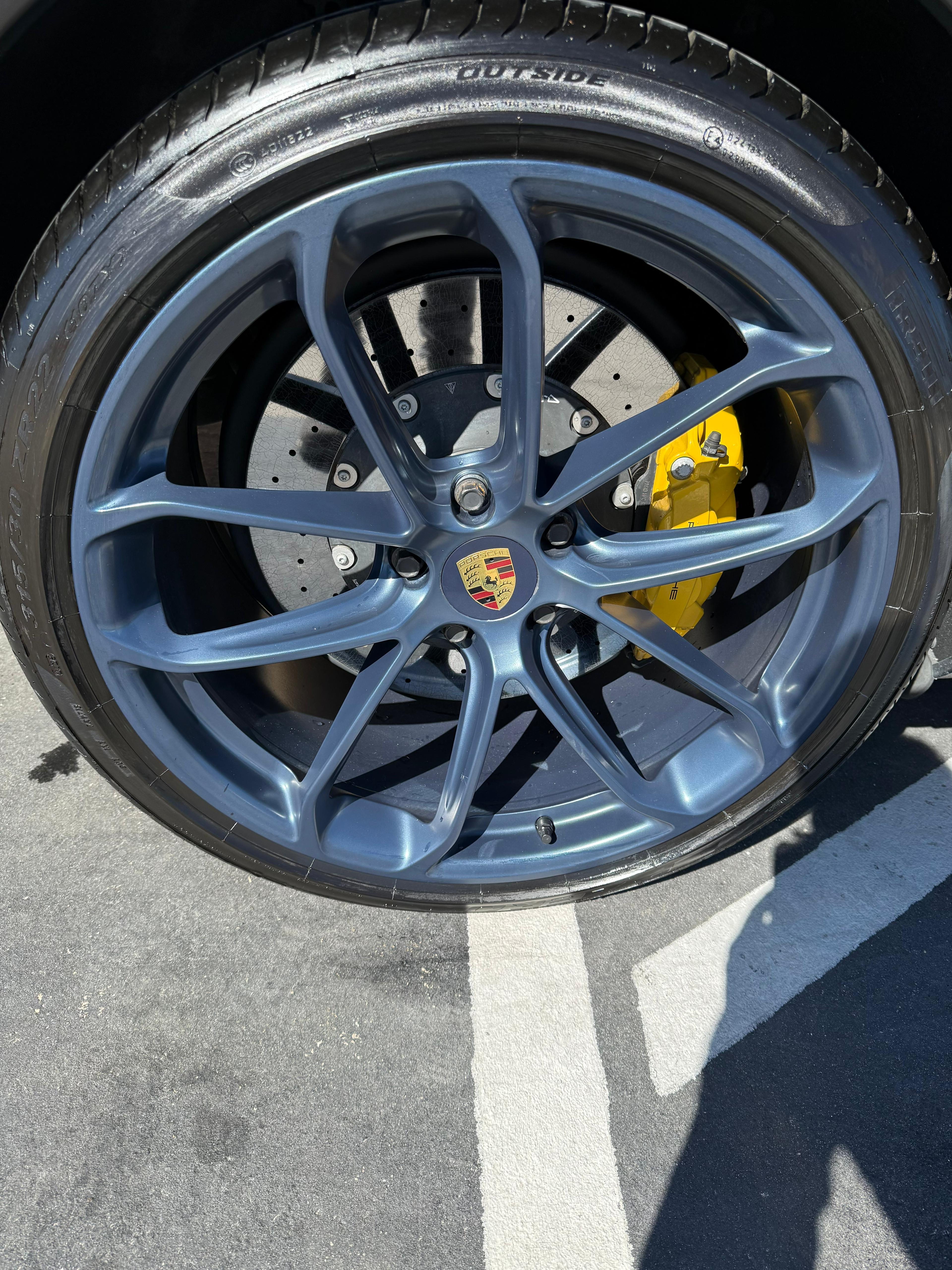 Porsche wheel with yellow brake calipers premium detail